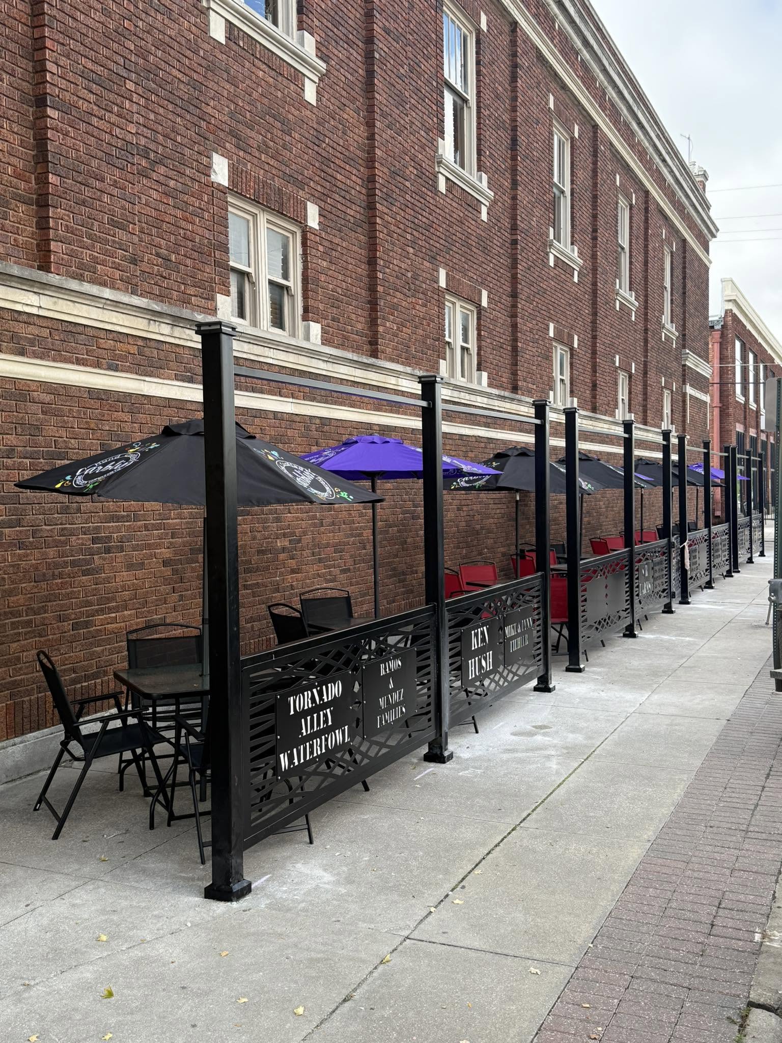Sidewalk patio seating with umbrellas on Commercial Street
